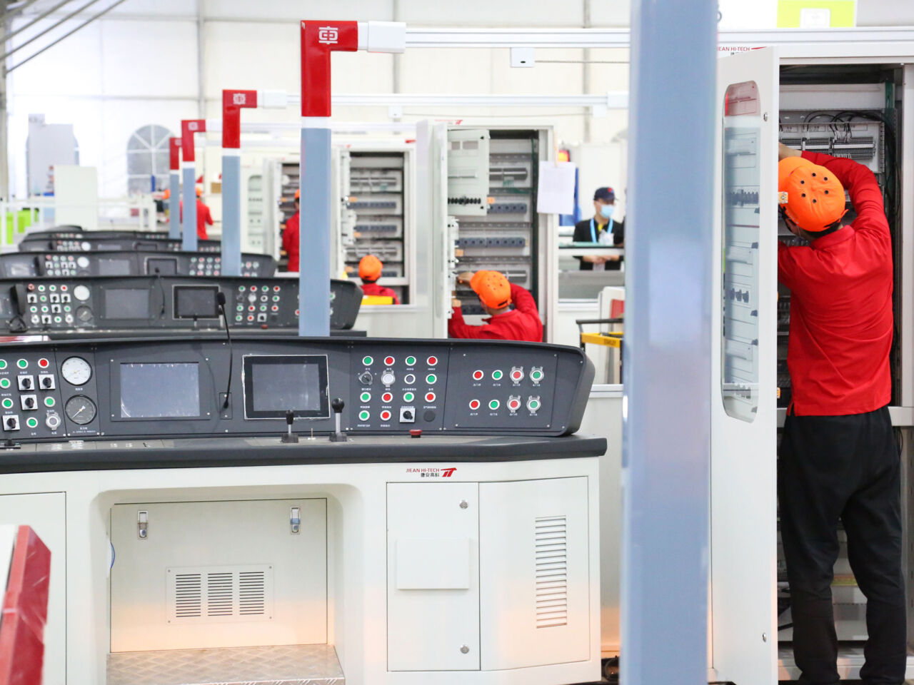 Competitors in Rail Vehicle Technology work on the wiring of systems for train transport.